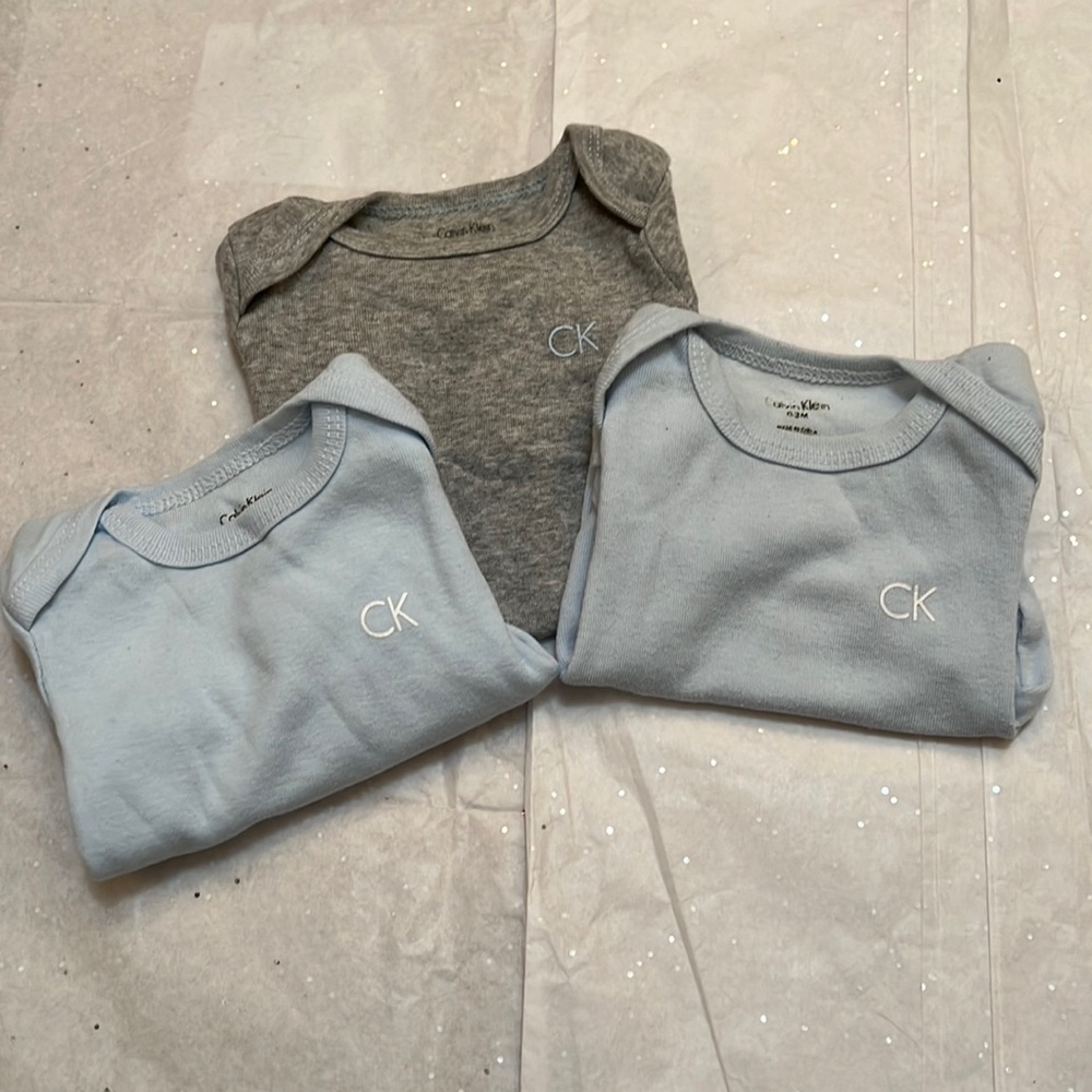 3 Calvin Klein onesies.